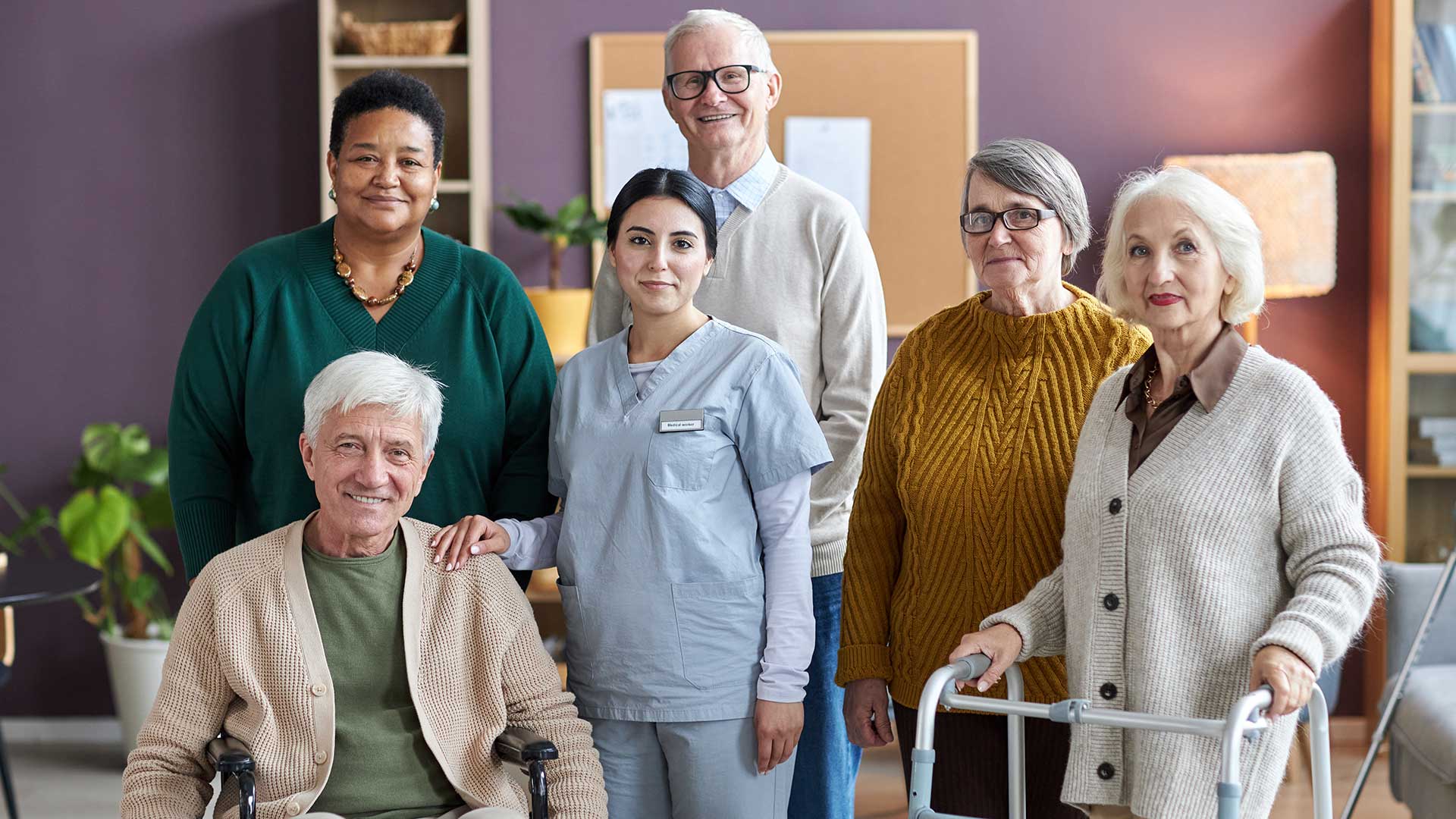 Professional caregiver assisting elderly woman at home
